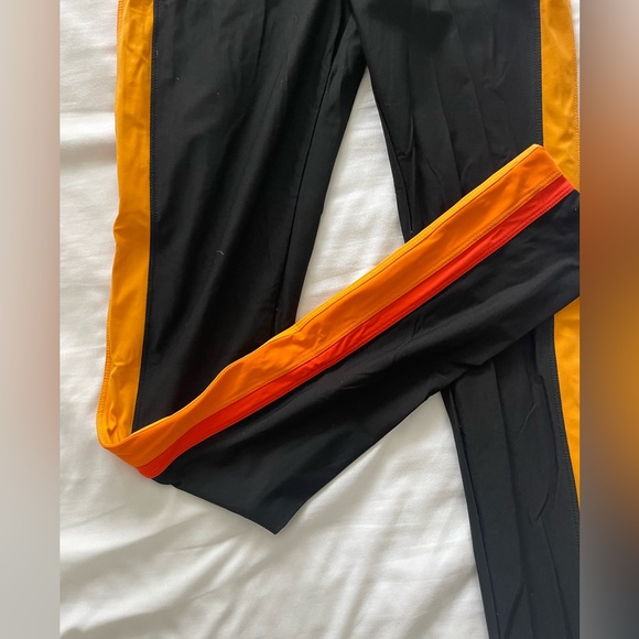 No Ka Oi black leggings with an orange striped detailing on the sides. - Picture 2 of 2
